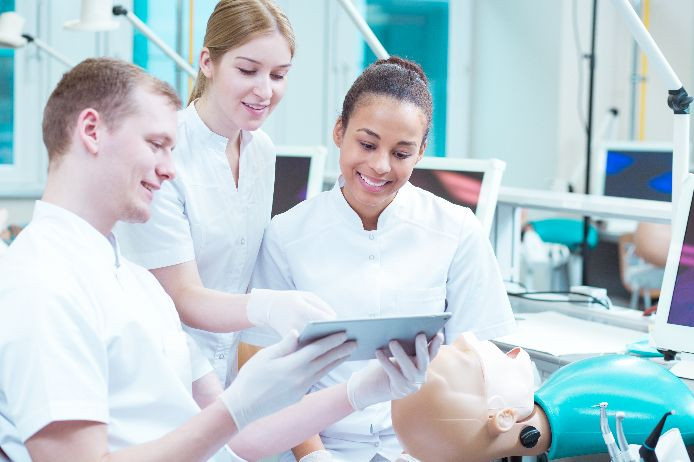 three dental nurses in a clinical laboratory