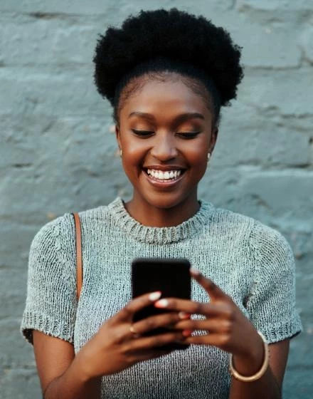 woman smiling at phone